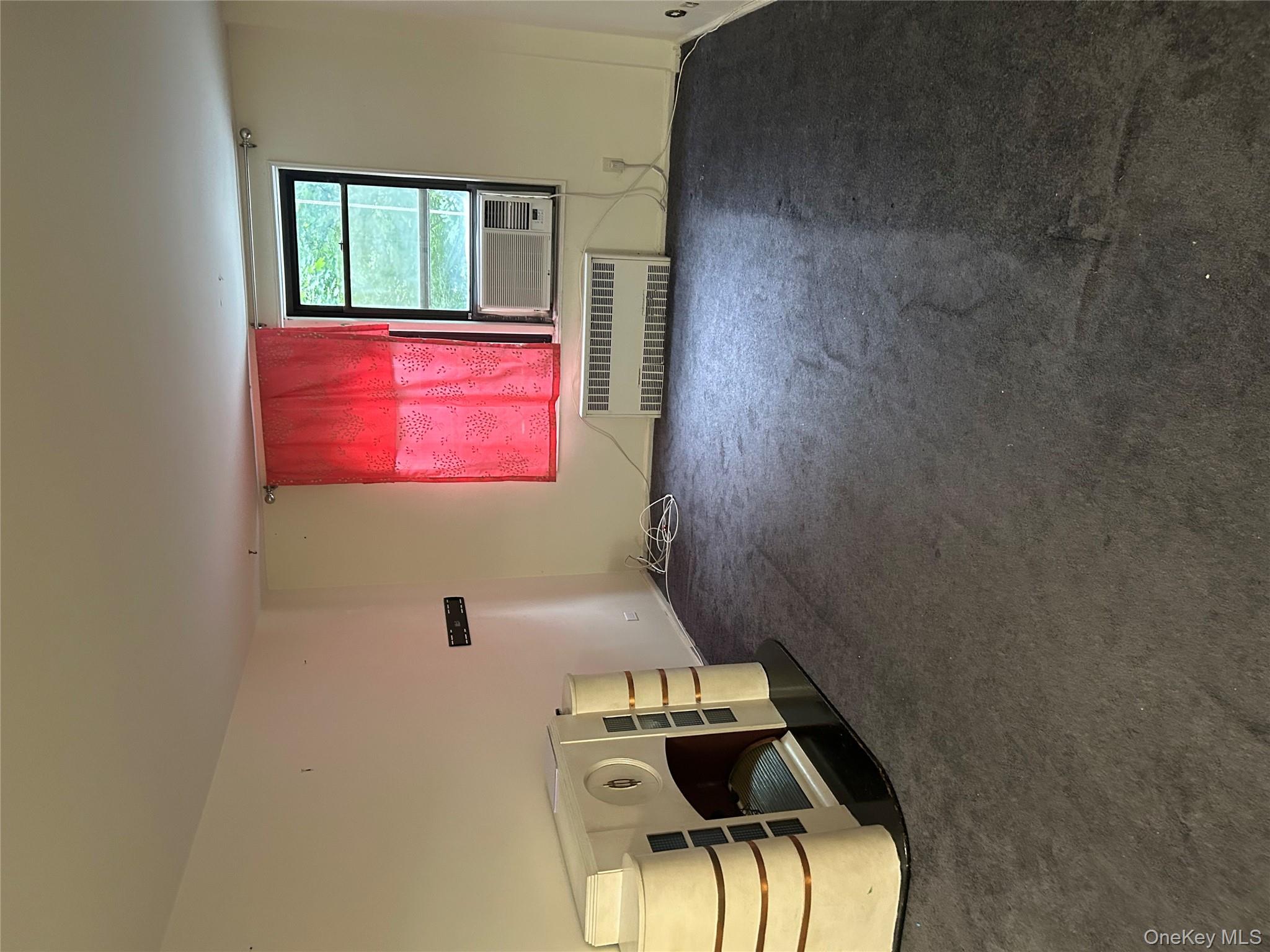 83-25 98th Street, Unit 2C Queens, NY 11421 - Photo 7 of 18 a view of a livingroom with furniture and a window