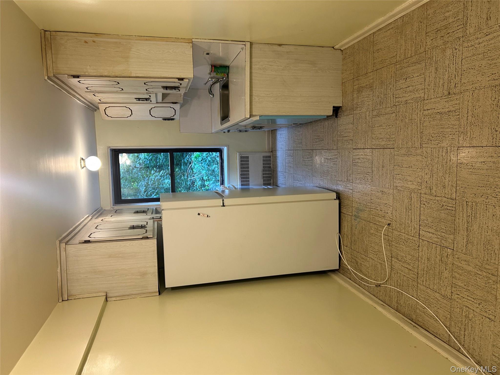 83-25 98th Street, Unit 2C Queens, NY 11421 - Photo 8 of 18 a kitchen with a refrigerator sink stove and cabinets