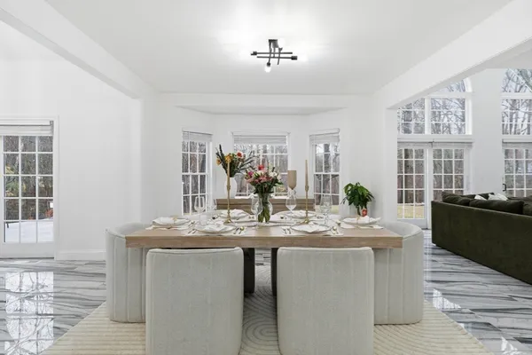 a dining hall with granite countertop a stove a sink dishwasher and a dining table with wooden floor