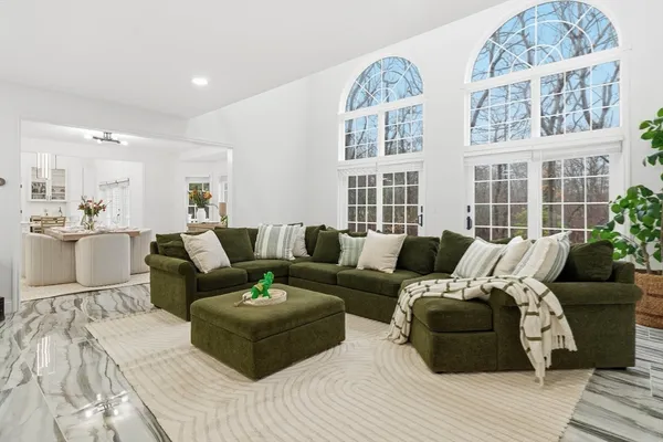 a living room with furniture window and wooden floor