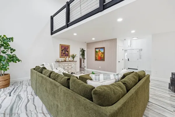a living room with furniture and a potted plant
