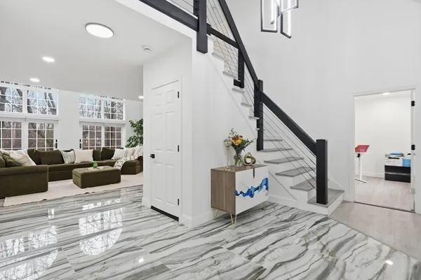a living room with furniture and stairs