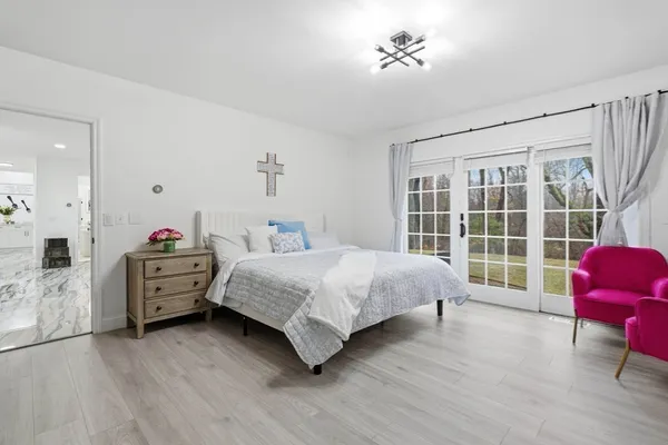 a bedroom with a bed and a chair