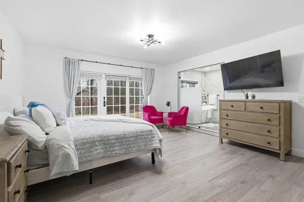 a bedroom with a bed and flat screen tv