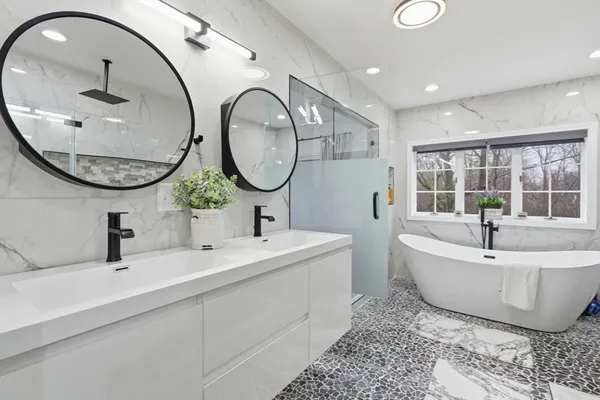 a spacious bathroom with a tub and mirror