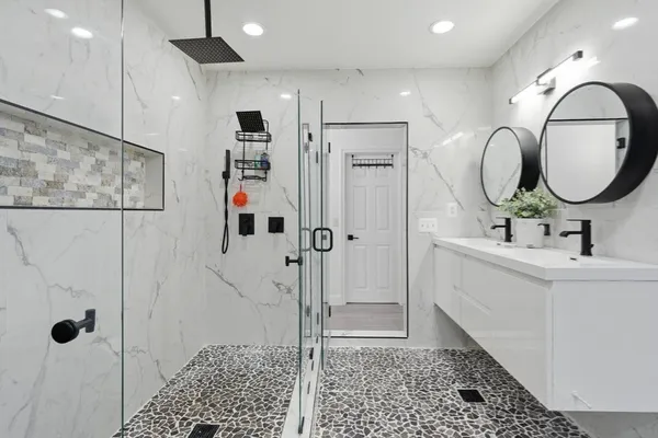 a bathroom with a sink a toilet and shower