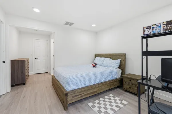 a bedroom with a bed and a lamp on table