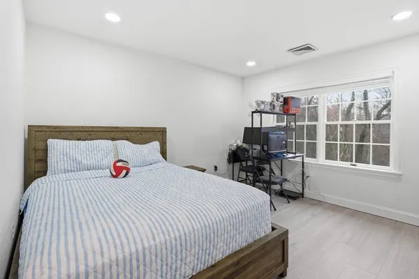 a bedroom with a bed and a large window