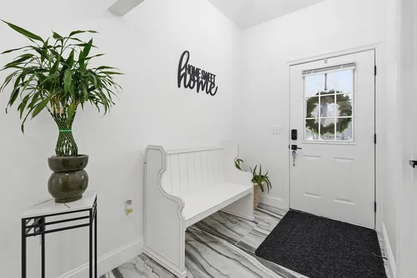 a view of a hallway with paintings on the wall