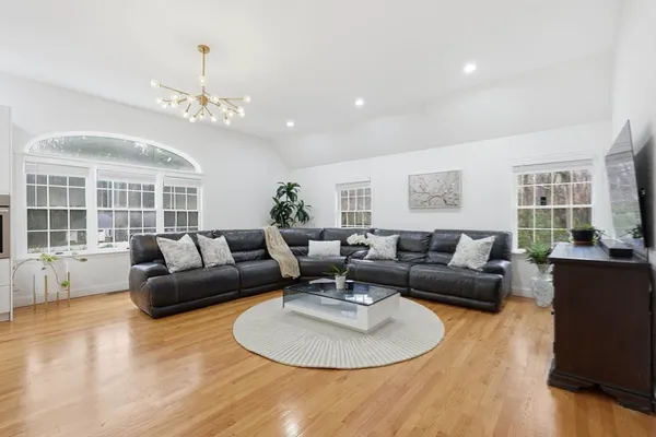 a living room with furniture chandelier and a table