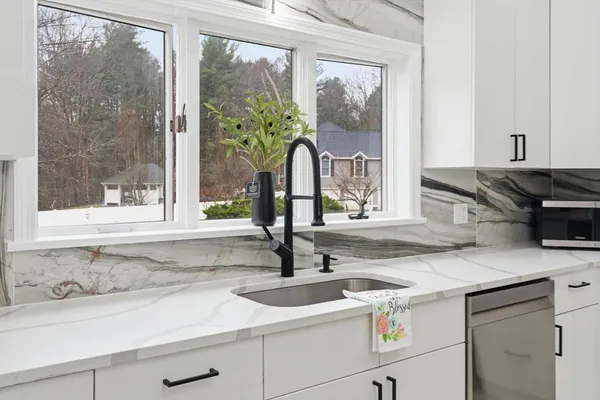 a kitchen with a sink and a window