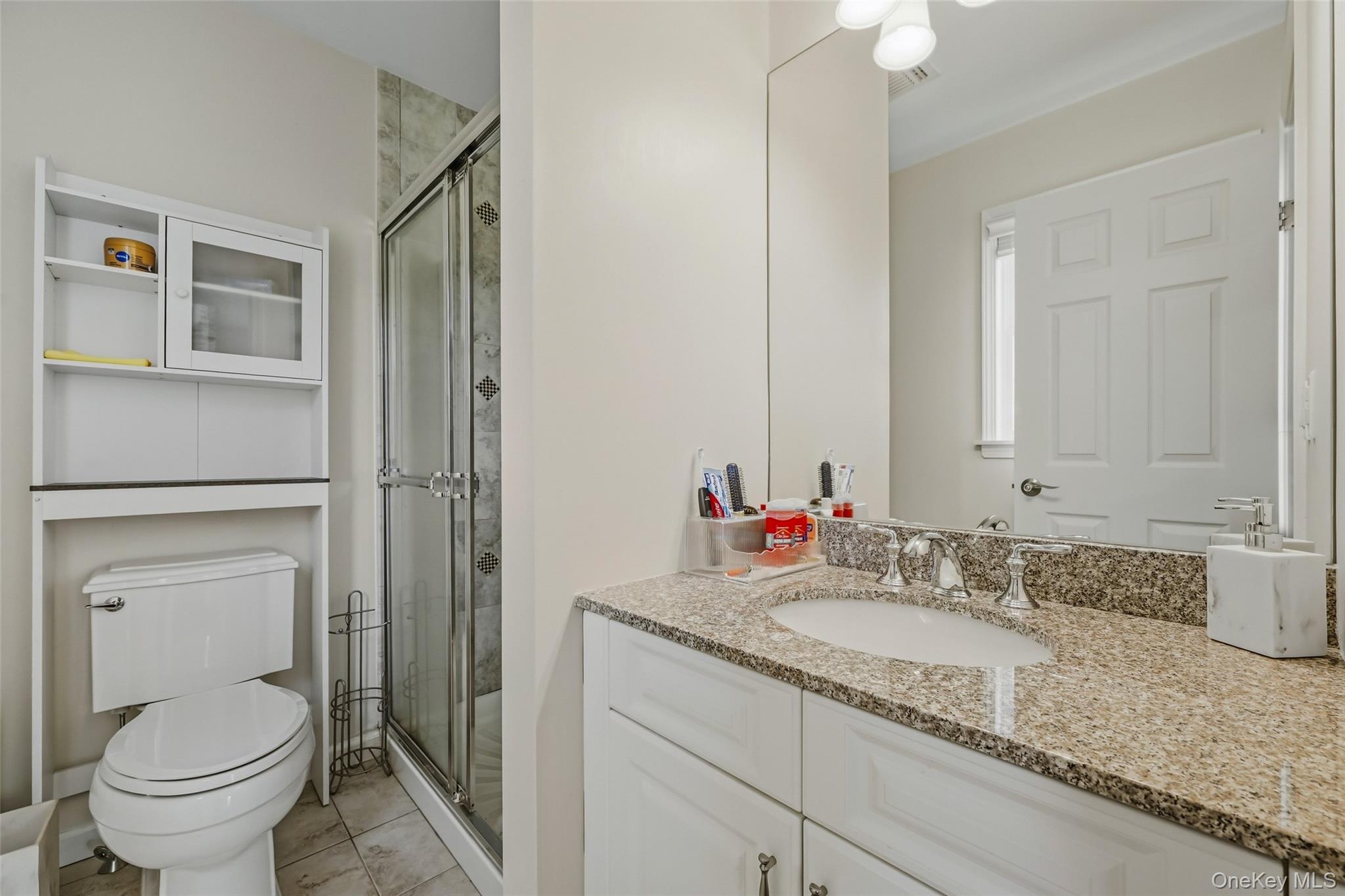 51 Meriwether Trail Congers, NY 10920 - Photo 36 of 50 Bathroom featuring a vanity with undermount sink, a glass-enclosed shower with tiled surround, and tiled flooring