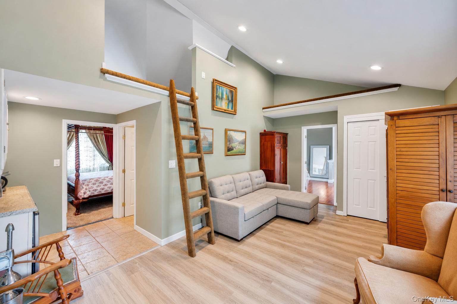 19 Joan Road Bay Shore, NY 11706 - Photo 31 of 50 Vaulted ceilings with recessed lighting over wood-finish flooring
