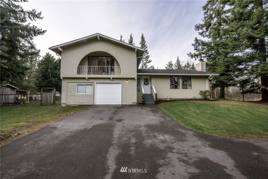 5215 Everson Goshen Road Bellingham, WA 98226 - Photo 1 of 25 a front view of a house with a yard and garage