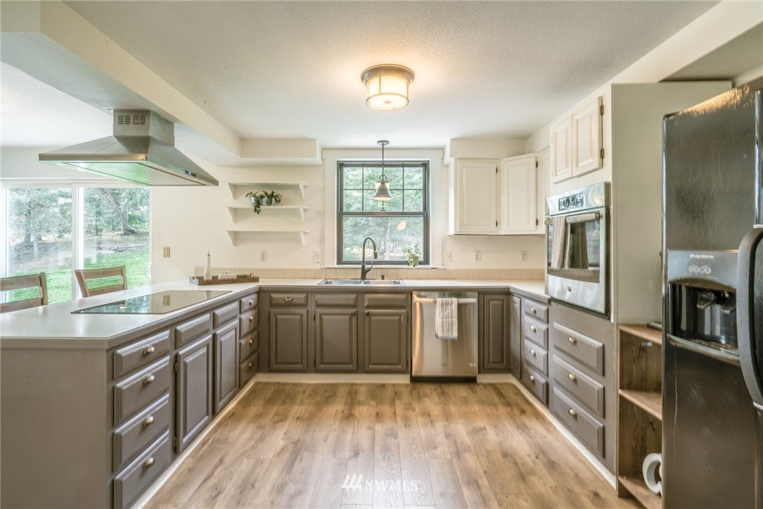 5215 Everson Goshen Road Bellingham, WA 98226 - Photo 12 of 25 a kitchen with stainless steel appliances granite countertop a stove a sink and a refrigerator