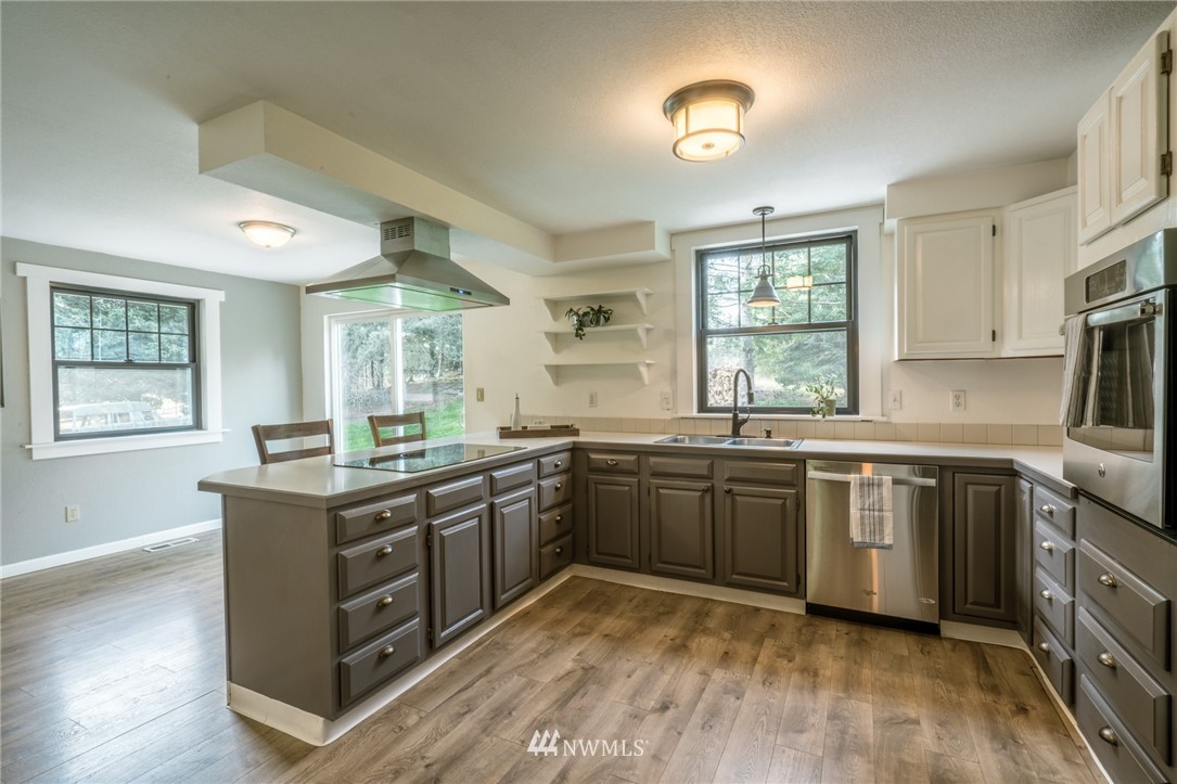 5215 Everson Goshen Road Bellingham, WA 98226 - Photo 13 of 25 a kitchen with stainless steel appliances granite countertop cabinets wooden floor and a window