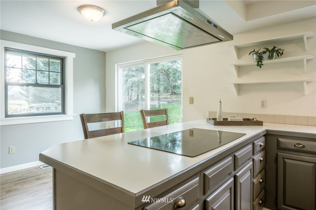 5215 Everson Goshen Road Bellingham, WA 98226 - Photo 16 of 25 a kitchen with a stove a sink and a refrigerator