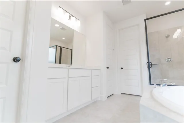 a bathroom with a bathtub and shower