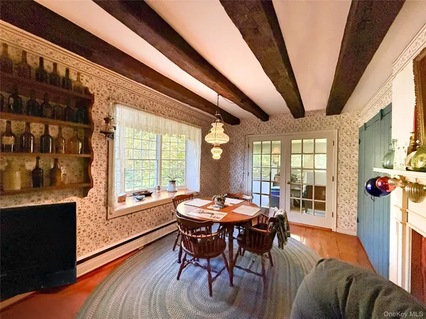 a dining room with furniture and wooden floor