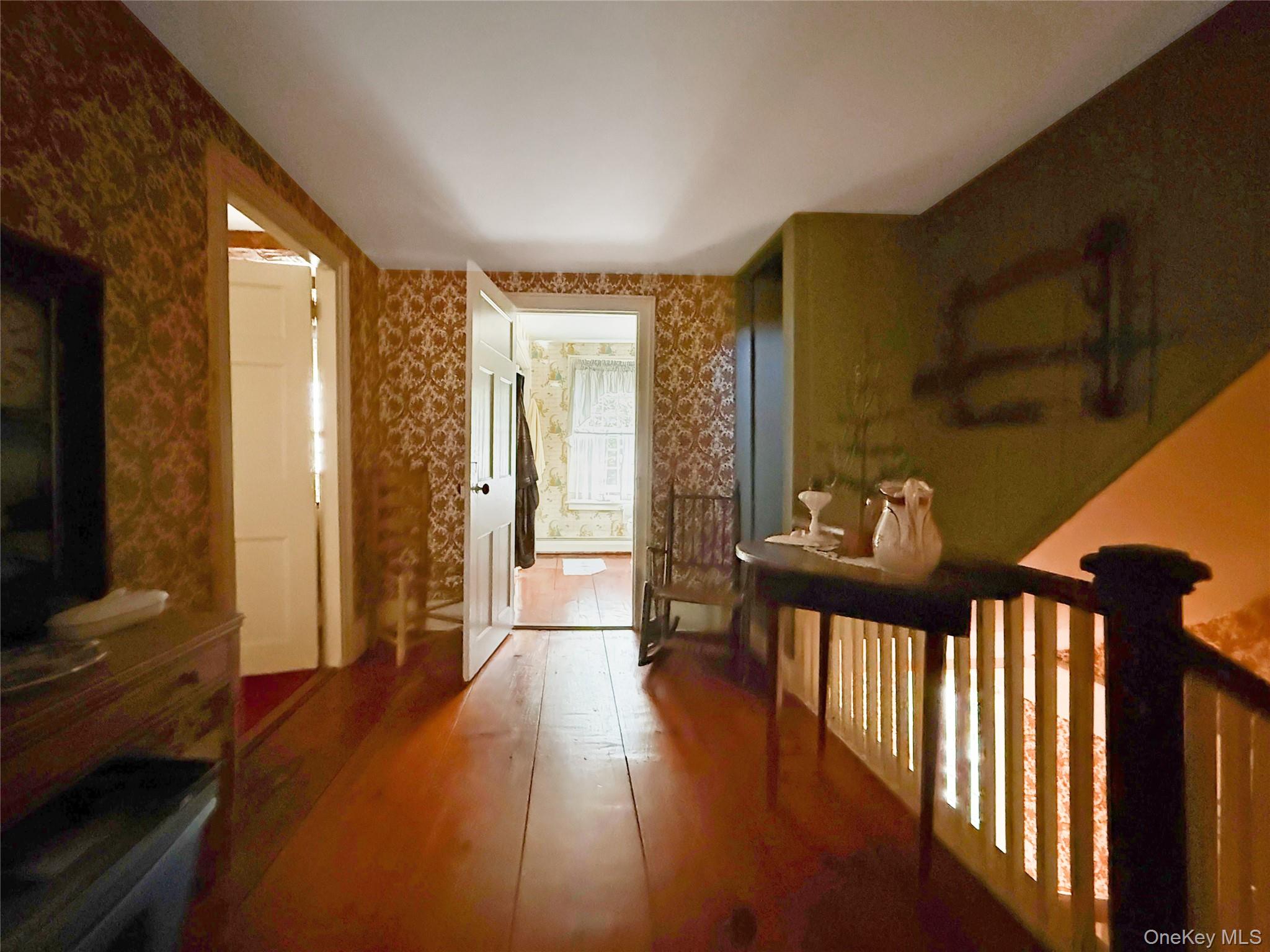 4 Plains Road Walden, NY 12586 - Photo 20 of 31 a view of a hallway with wooden floor and a flat screen tv