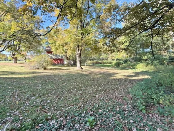 a view of dirt yard with a trees