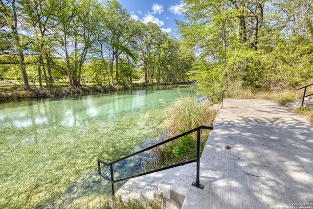 a view of a lake with a house in the background