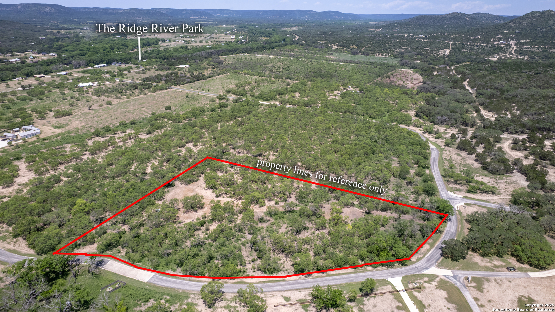405 Ridge Loop Rio Frio, TX 78879 - Photo 22 of 32 a view of a lush green hillside and a houses