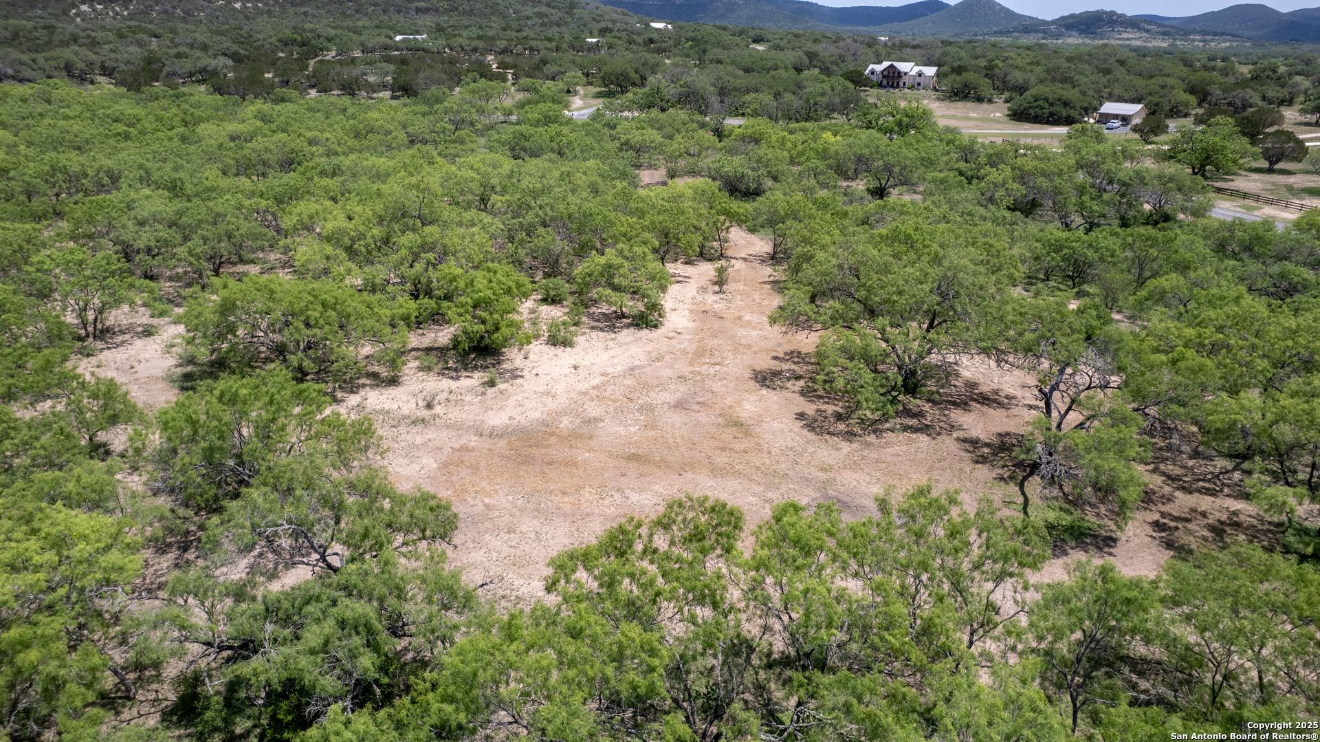 405 Ridge Loop Rio Frio, TX 78879 - Photo 28 of 32 an aerial view of residential house with outdoor space and trees all around