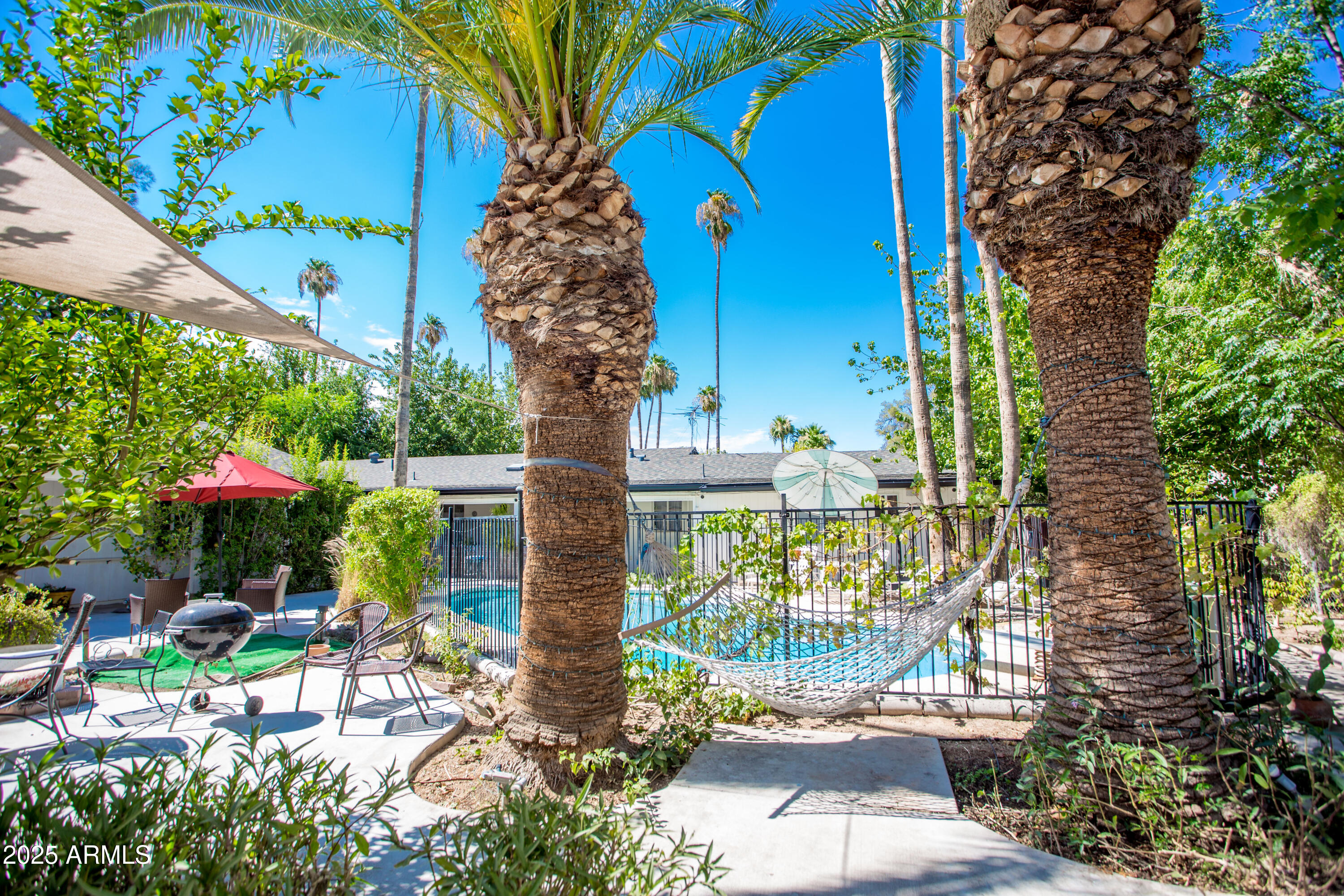 37 West Pasadena Avenue Phoenix, AZ 85013 - Photo 30 of 37 a view of a chairs and table in patio with wooden fence