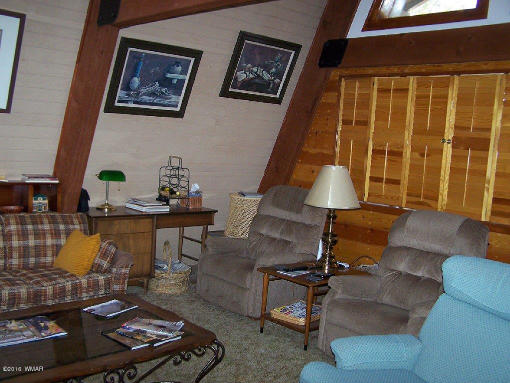 3156 Chevelon Road Overgaard, AZ 85933 - Photo 2 of 46 a living room with furniture and a window