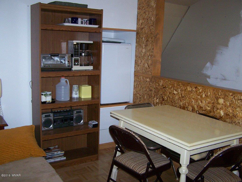 3156 Chevelon Road Overgaard, AZ 85933 - Photo 38 of 46 a dining room with a table and chairs
