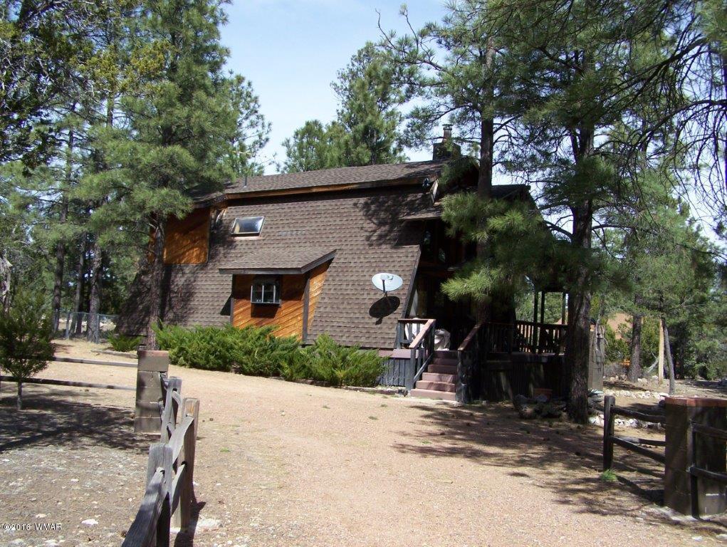 3156 Chevelon Road Overgaard, AZ 85933 - Photo 46 of 46 a front view of a house with a yard