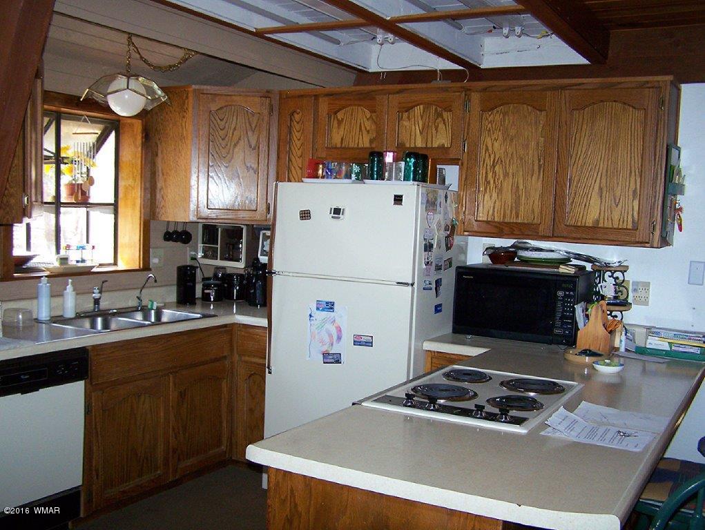 3156 Chevelon Road Overgaard, AZ 85933 - Photo 5 of 46 a kitchen with a stove a refrigerator and a sink