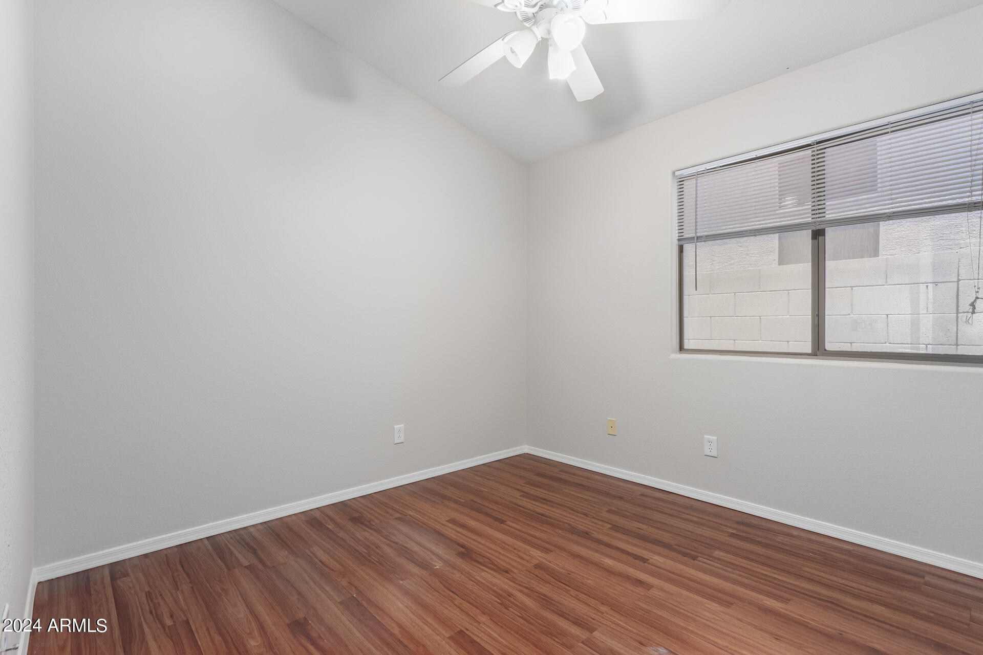 4007 East Ironhorse Road Gilbert, AZ 85297 - Photo 23 of 33 a view of an empty room with wooden floor and a window