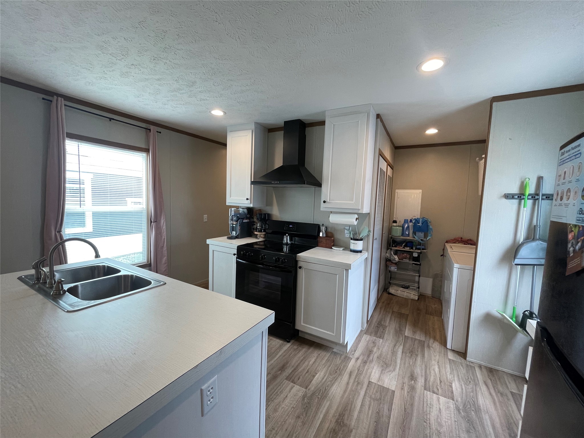 20410 Telge Road, Unit 144 Tomball, TX 77377 - Photo 14 of 20 a kitchen with sink refrigerator and stove