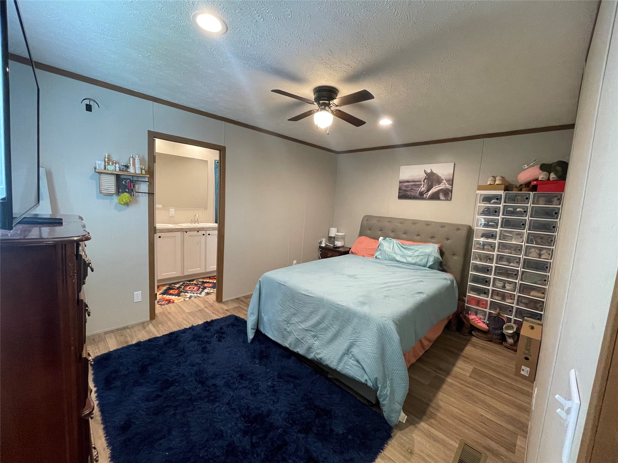 20410 Telge Road, Unit 144 Tomball, TX 77377 - Photo 5 of 20 a bedroom with a large bed and a chandelier