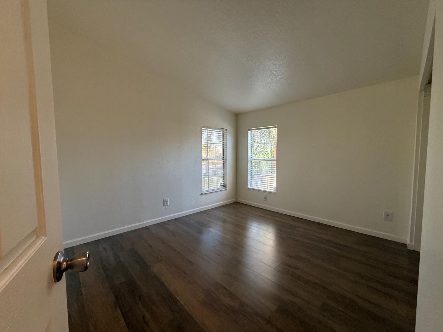 908 Atlantic Street, Unit 33 Roseville, CA 95678 - Photo 11 of 31 an empty room with wooden floor and windows