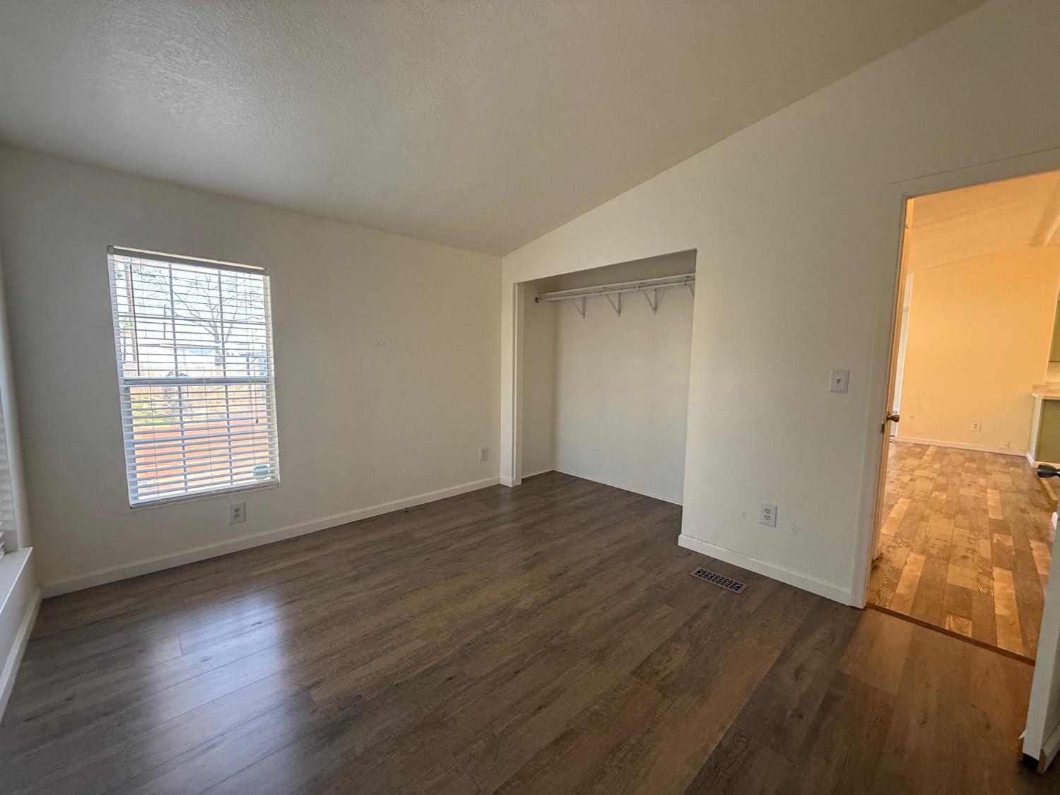 908 Atlantic Street, Unit 33 Roseville, CA 95678 - Photo 12 of 31 an empty room with wooden floor and windows