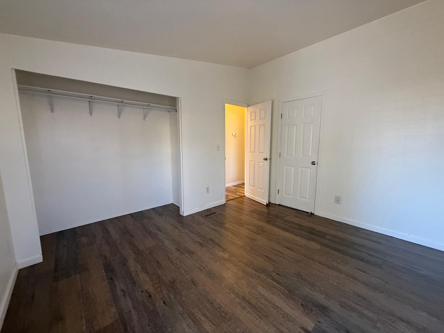 908 Atlantic Street, Unit 33 Roseville, CA 95678 - Photo 13 of 31 a view of an empty room with wooden floor and a window