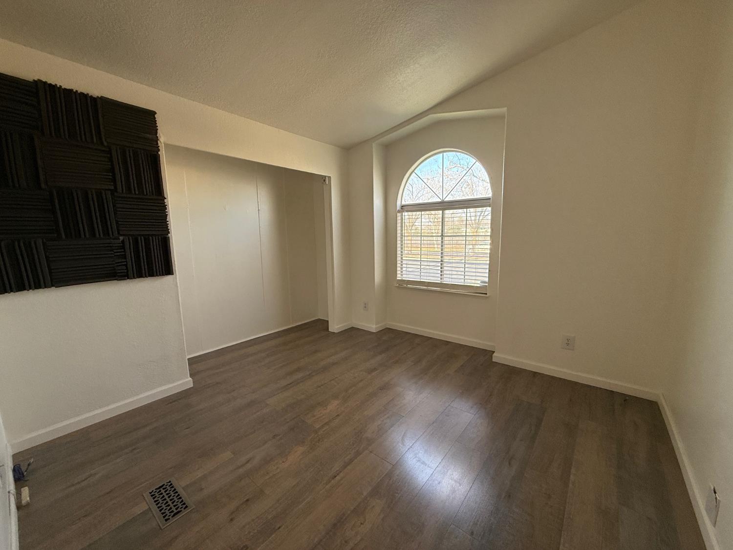 908 Atlantic Street, Unit 33 Roseville, CA 95678 - Photo 14 of 31 an empty room with wooden floor and windows