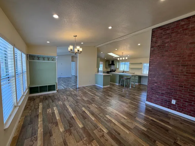 a view of kitchen and hall with wooden floor