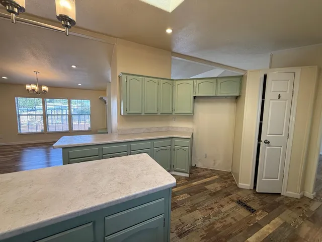 a kitchen with a refrigerator and countertop