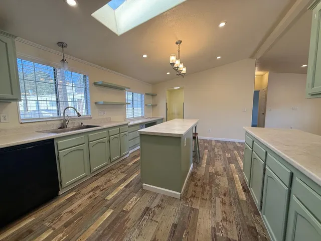 a kitchen with lots of counter top space and wooden floor