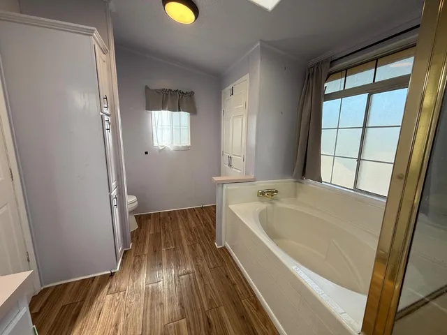 a bathroom with a bathtub and a window