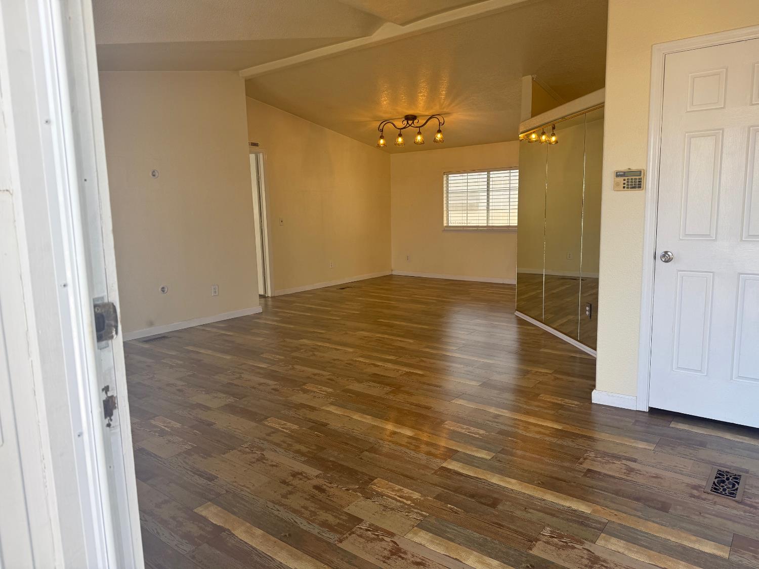 908 Atlantic Street, Unit 33 Roseville, CA 95678 - Photo 6 of 31 an empty room with wooden floor and windows