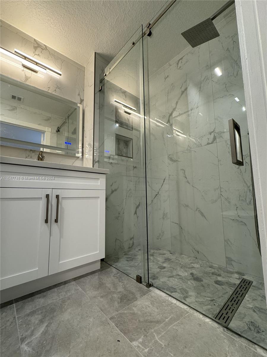 Richmond West Miami, FL 33187 - Photo 4 of 10 a bathroom with a shower and a sink