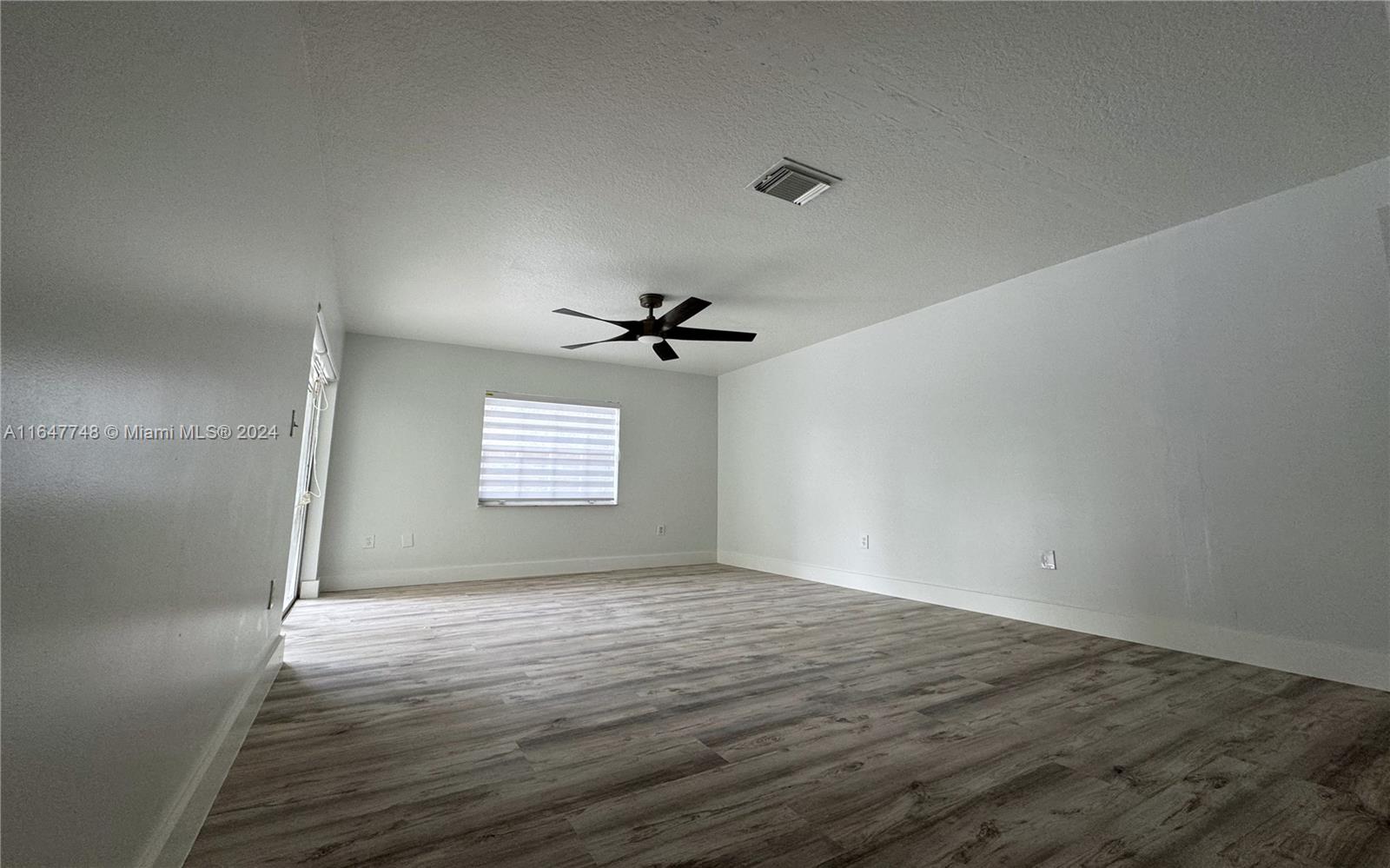 Richmond West Miami, FL 33187 - Photo 6 of 10 an empty room with windows and fan