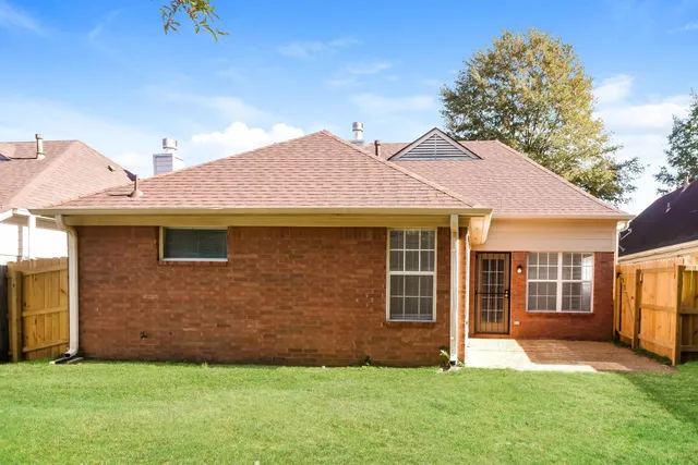 a front view of a house with a garden and yard