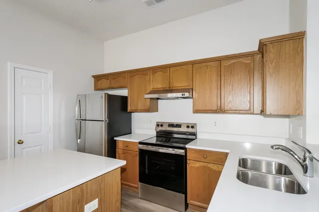 a kitchen that has a sink and a stove in it