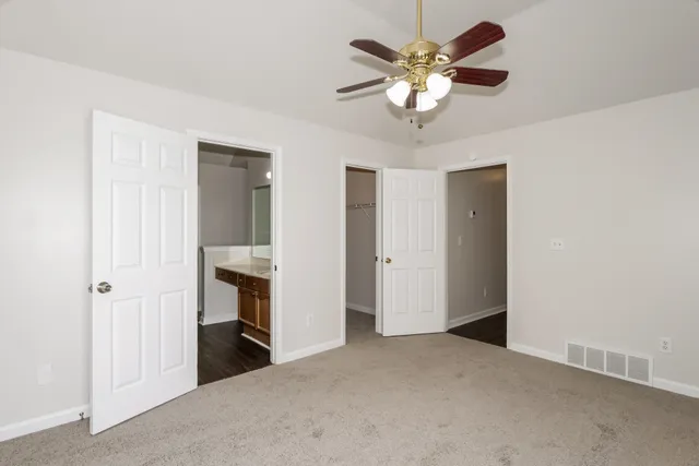 a view of a livingroom with a ceiling fan a flat screen tv and a ceiling fan